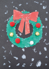 A child's Christmas card design featuring a hand painted wreath with pompoms and a bow.